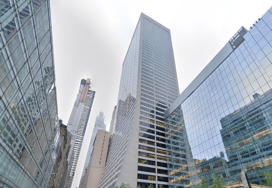 Skyscrapers with glass facades reflecting a cloudy sky