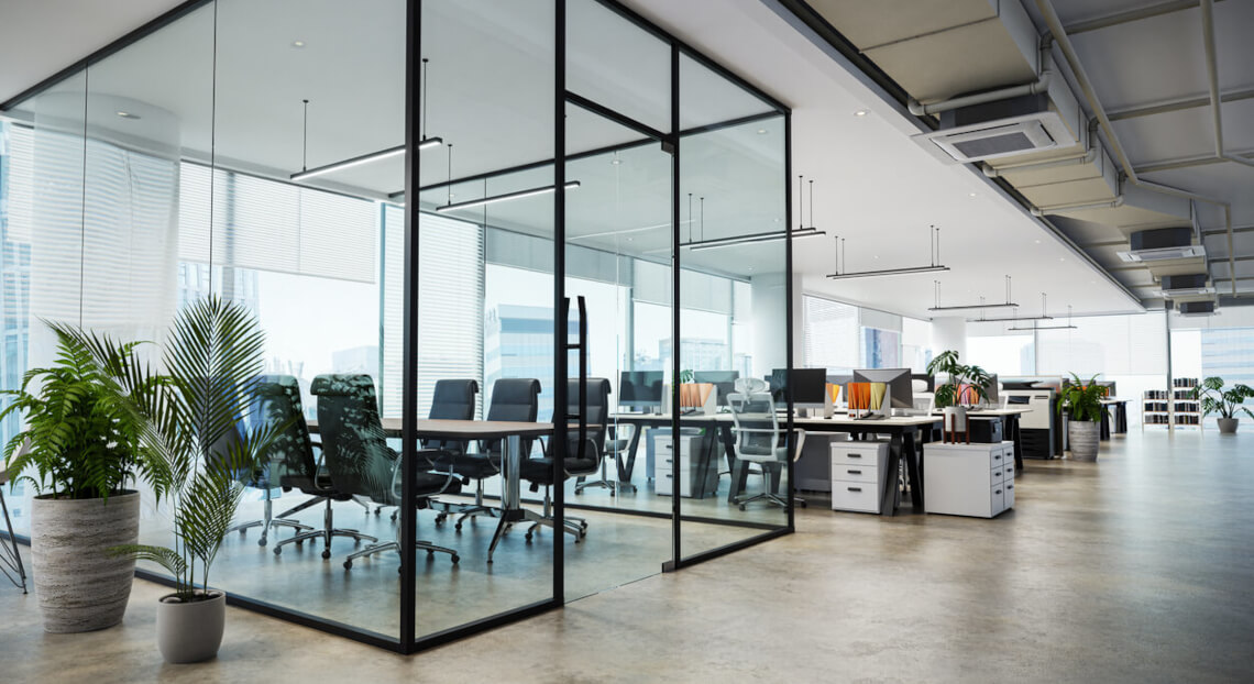 Modern office with exposed concrete floor and glass conference room.