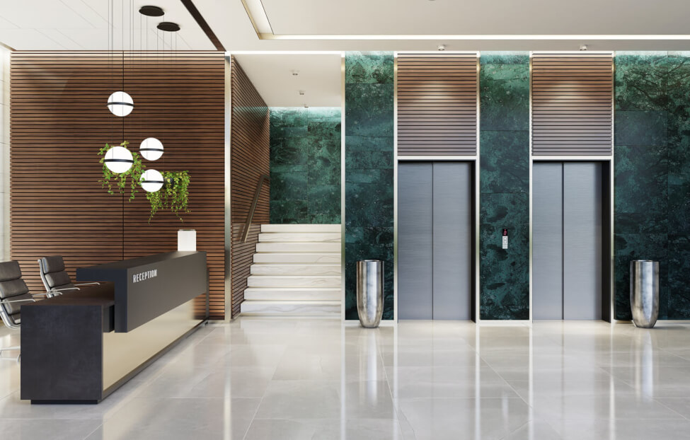 Modern NYC office lobby with elevators, stairs and a long reception desk
