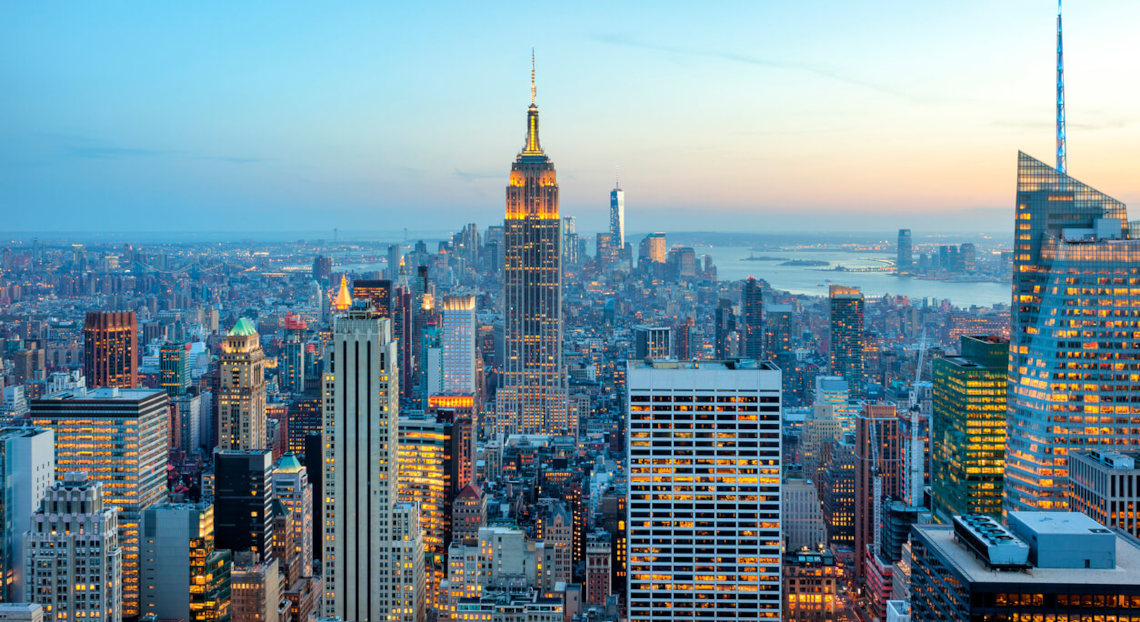 Panoramic view of Manhattan with its skyscrapers lit up at twilight, New York City