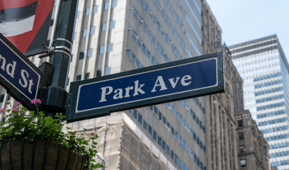 Park Ave street sign hanging from a lamppost, showcasing a classic New York City streetscape