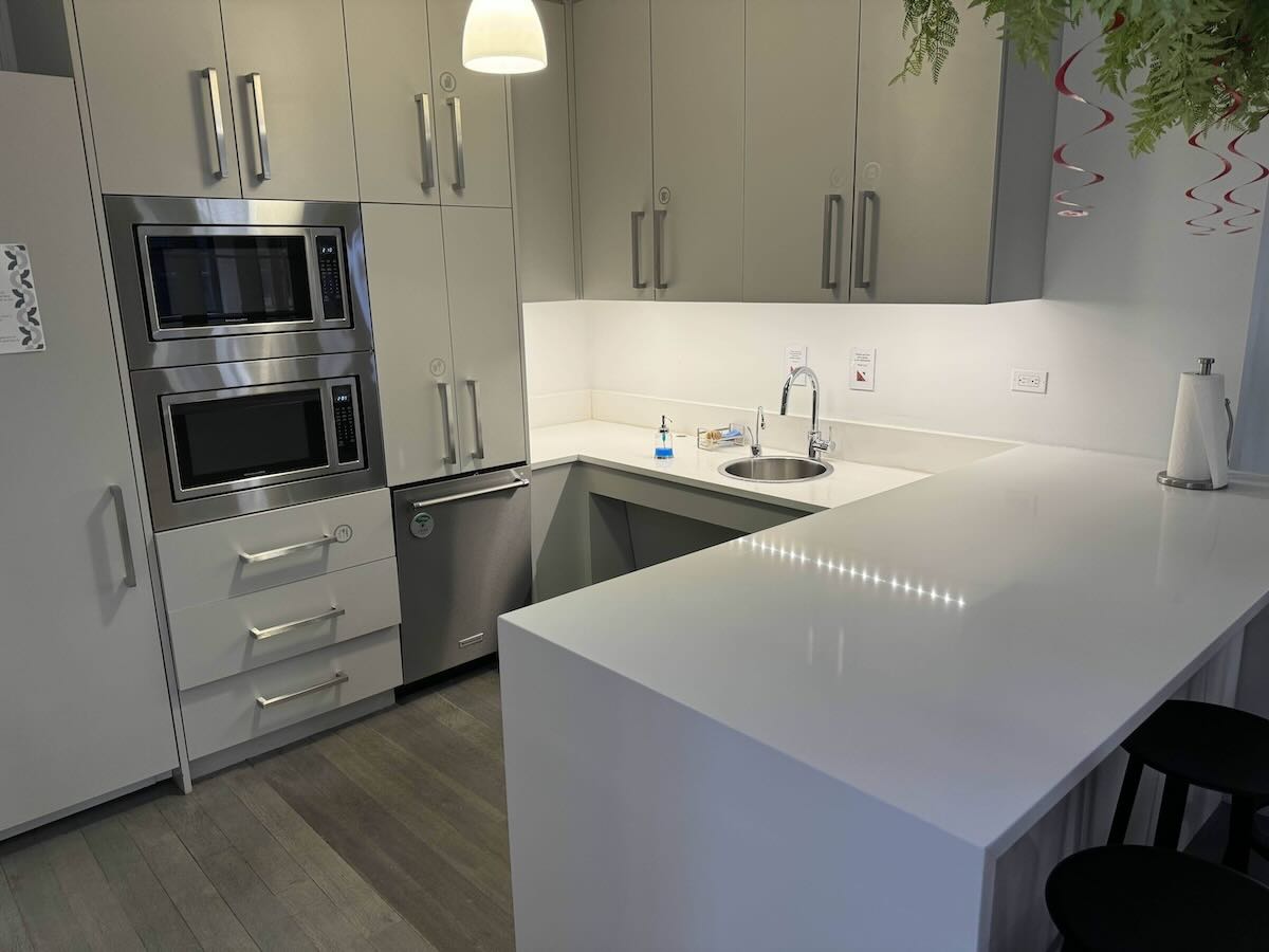 Modern kitchen, white cabinets & countertop, stainless appliances