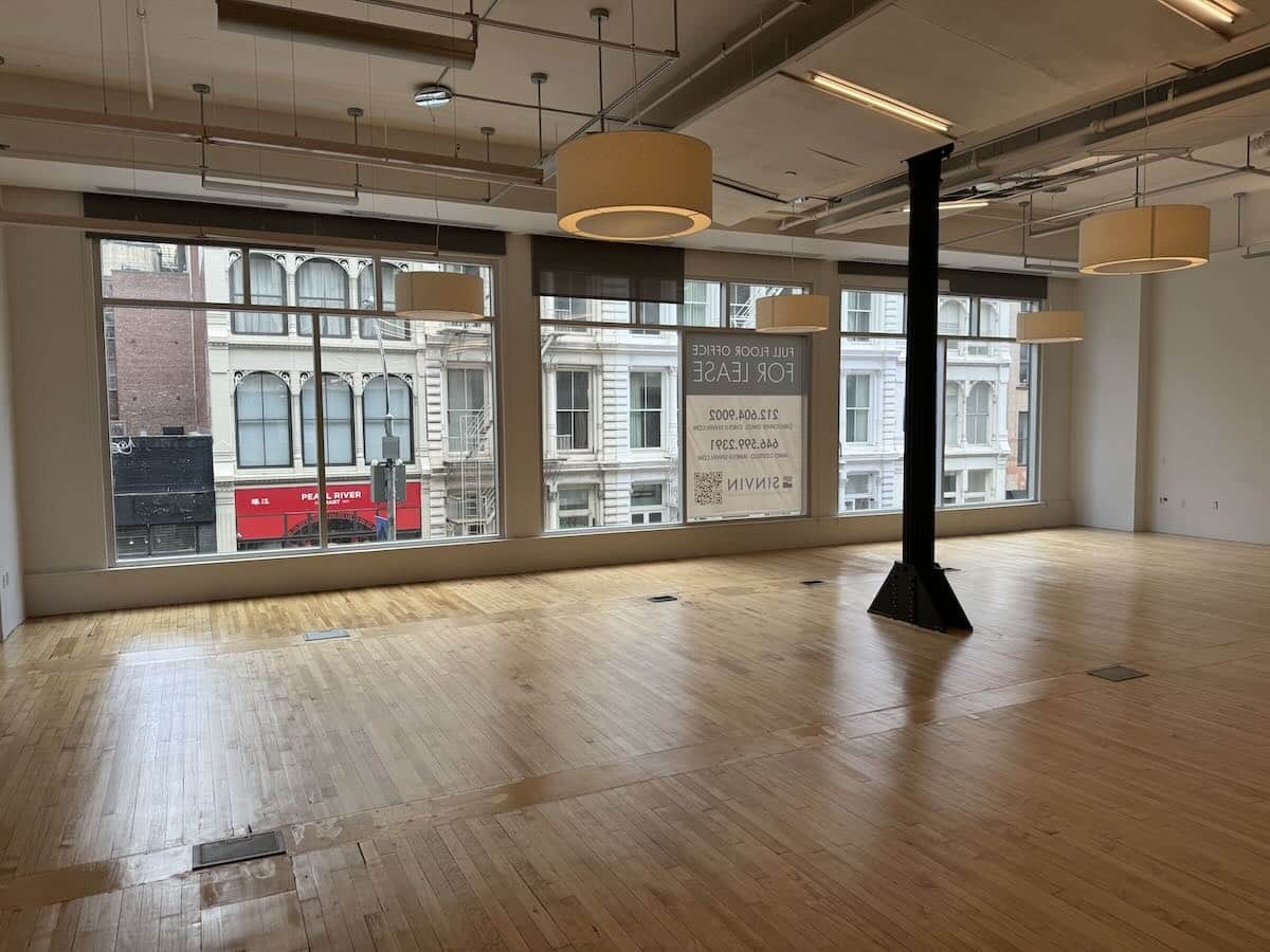 Unfurnished office on 2nd floor, wooden floors, large windows.