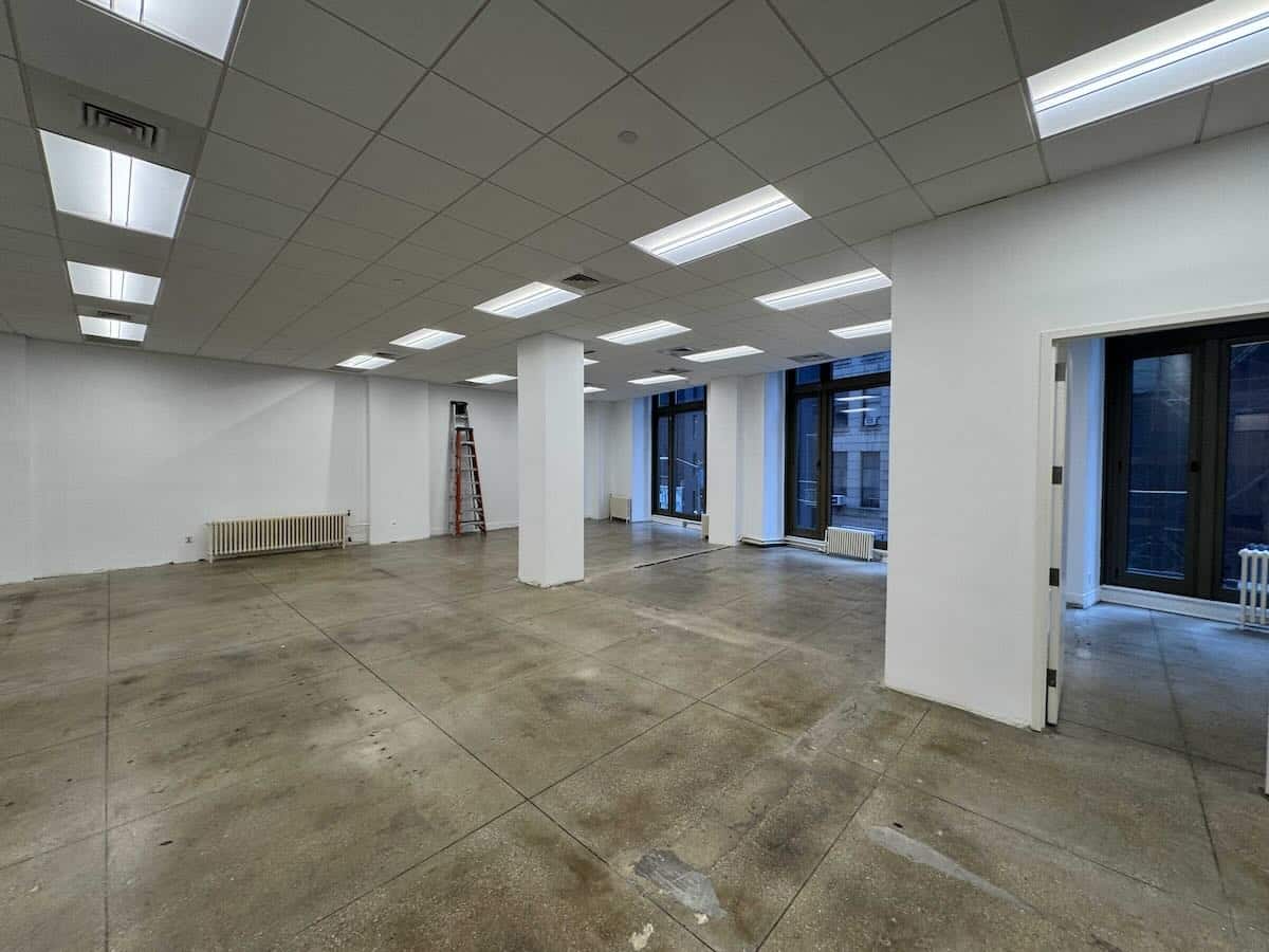 Empty second-floor office at 15 Maiden Lane with concrete floors and white walls.