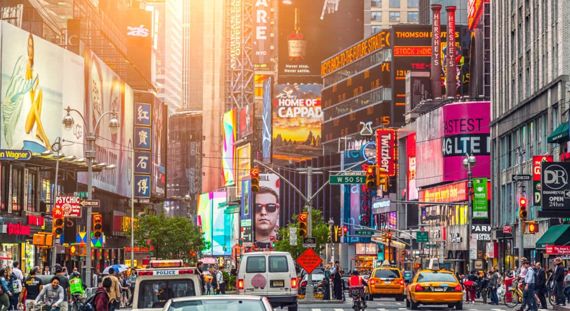 The iconic Times Square in New York city, bustling with people, cars and illuminated billboards