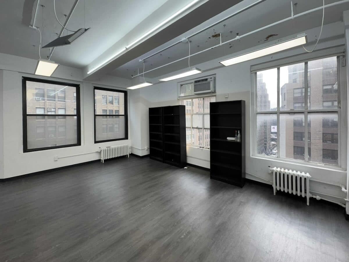 Bright office with large windows on Eighth Avenue, dark wood floor