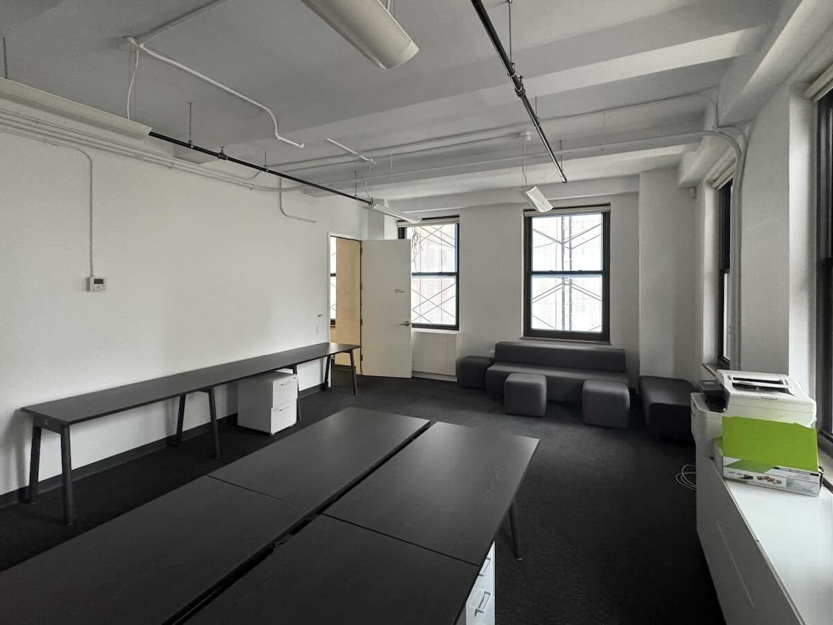 Modern office at 315 Madison Ave with tables, benches, and natural light.