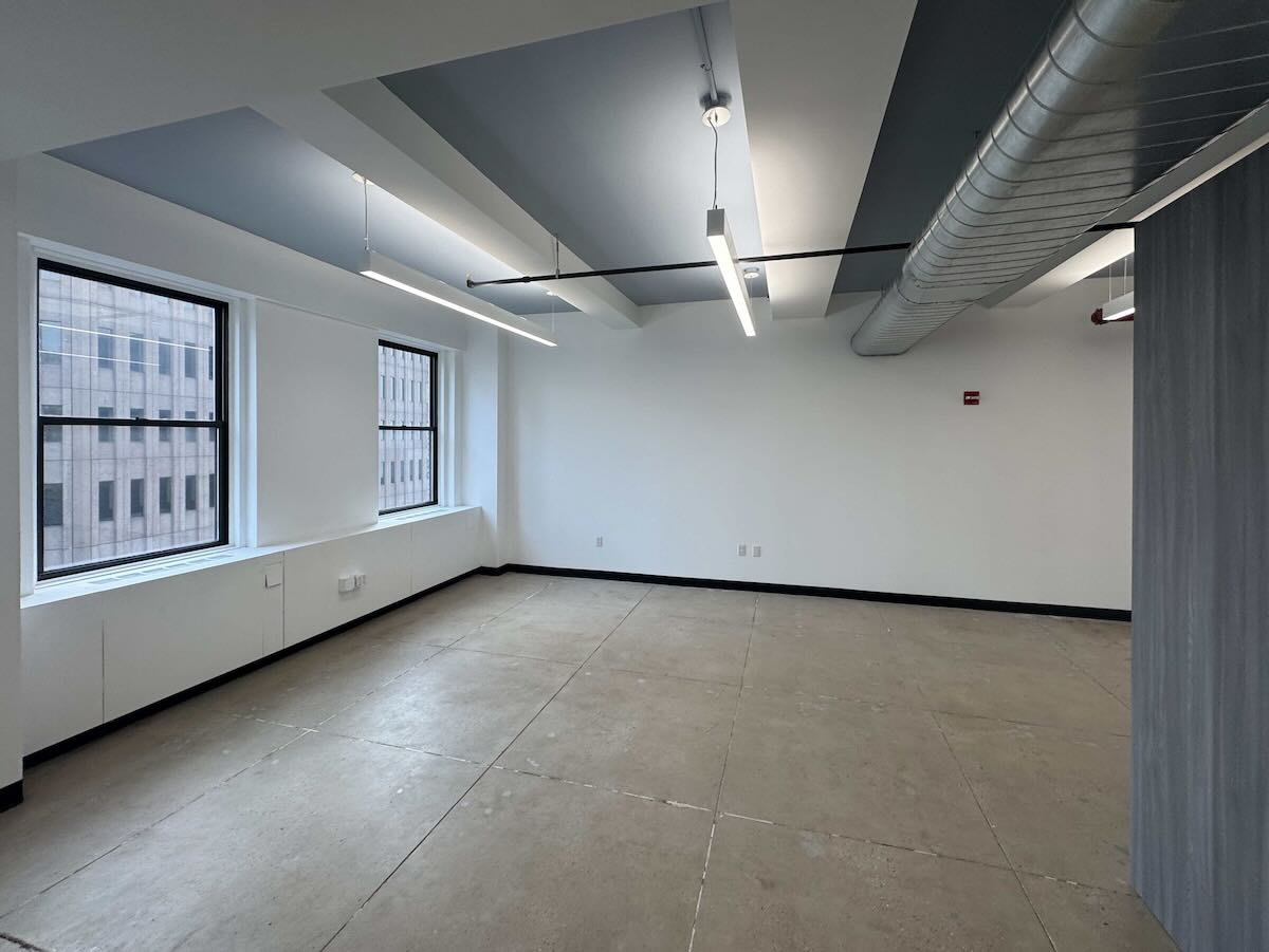 Empty office with large windows and cityscape view