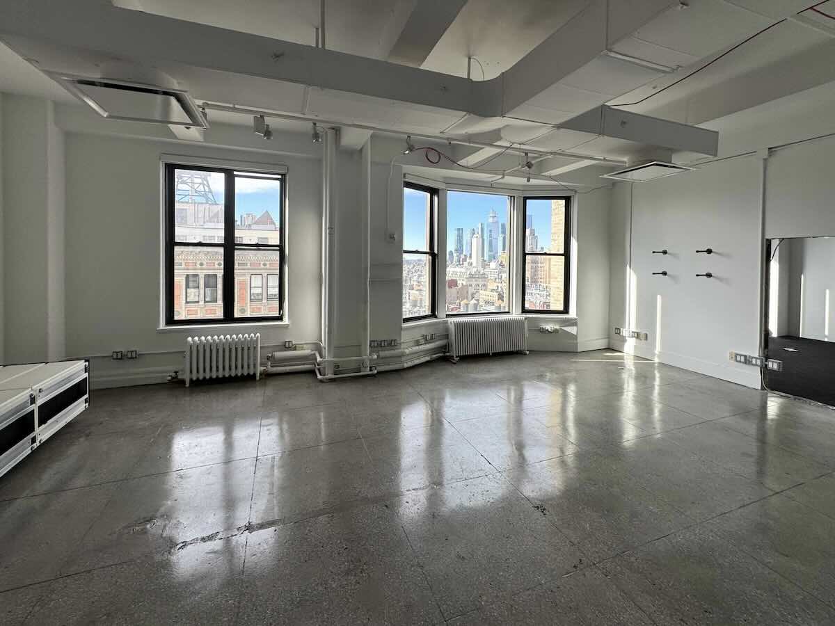 Office space at 215 Park Ave South with large windows and city view.