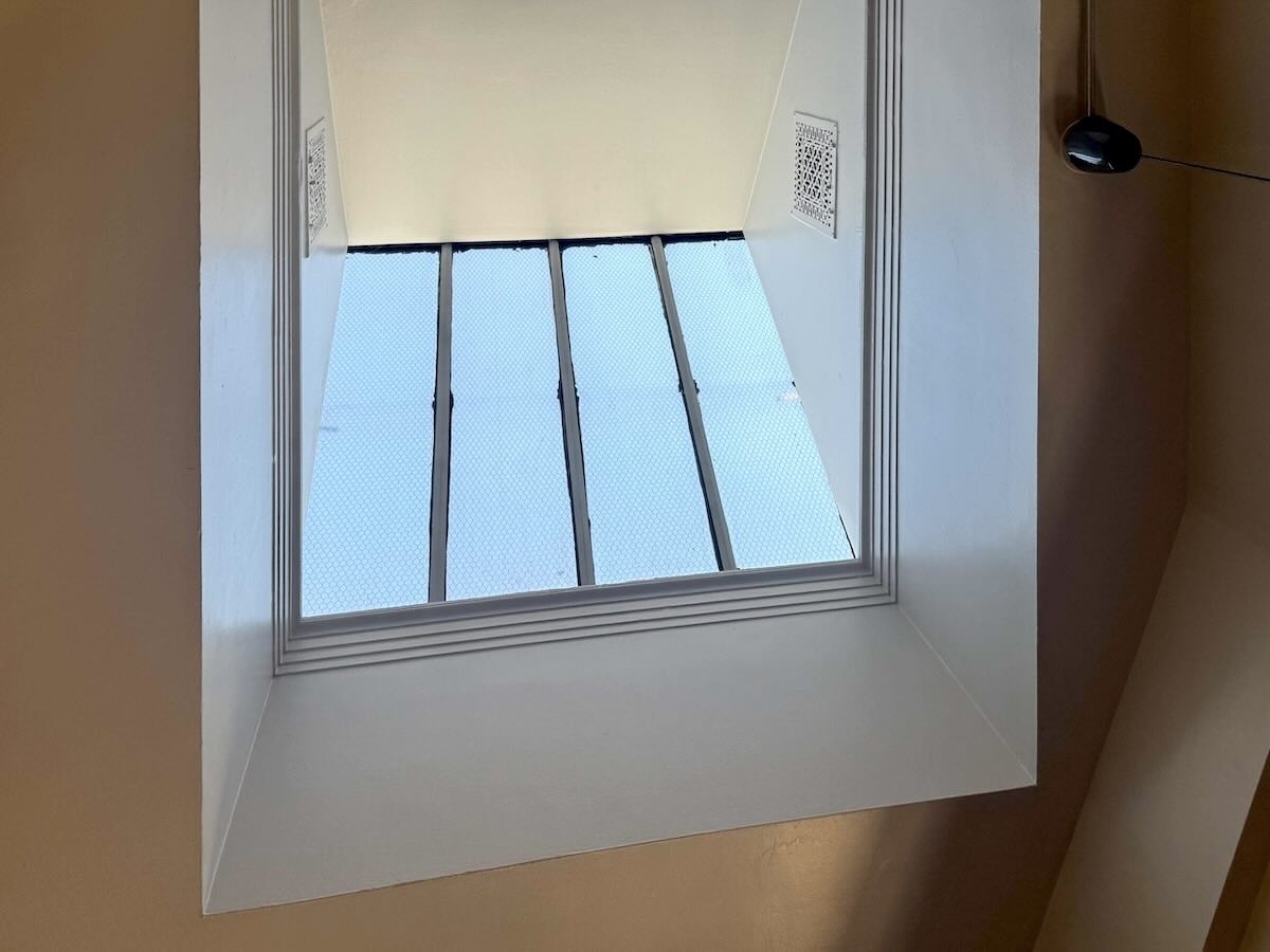 Skylight with grid pattern in off-white ceiling