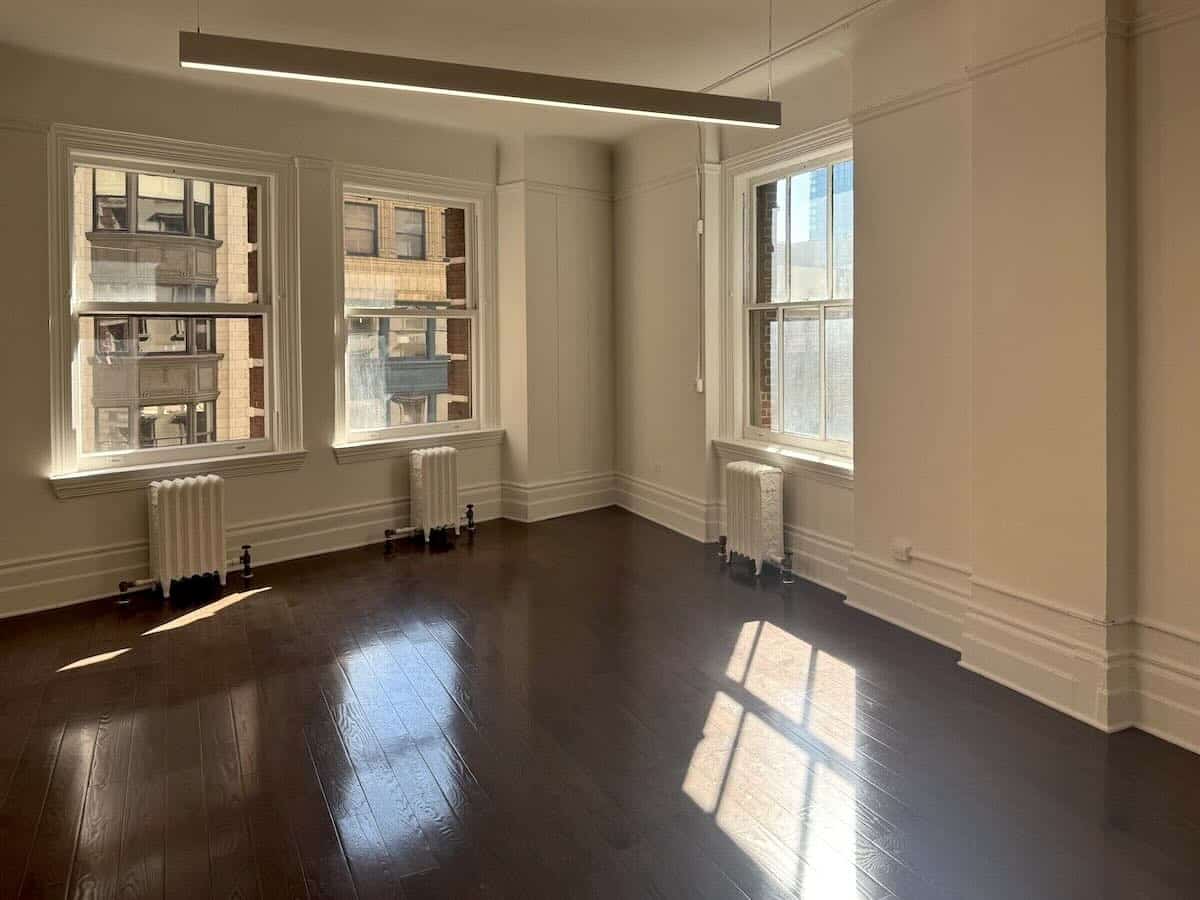 Empty room with wood floors, large windows at 1133 Broadway, #630