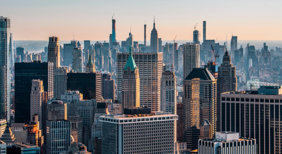 Aerial view of city's skyline with Class B skyscrapers at sunset.