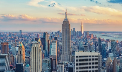 Aerial view of city skyline at sunset, Empire State Building centered.