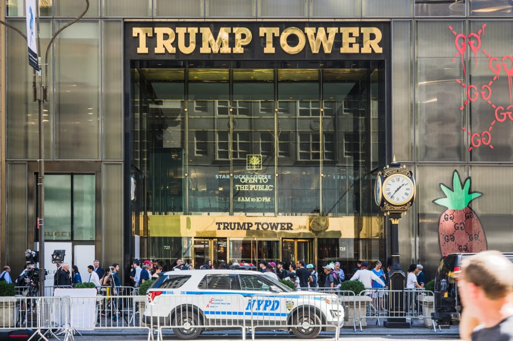 Trump Tower entrance in NYC with NYPD and gathered crowd.