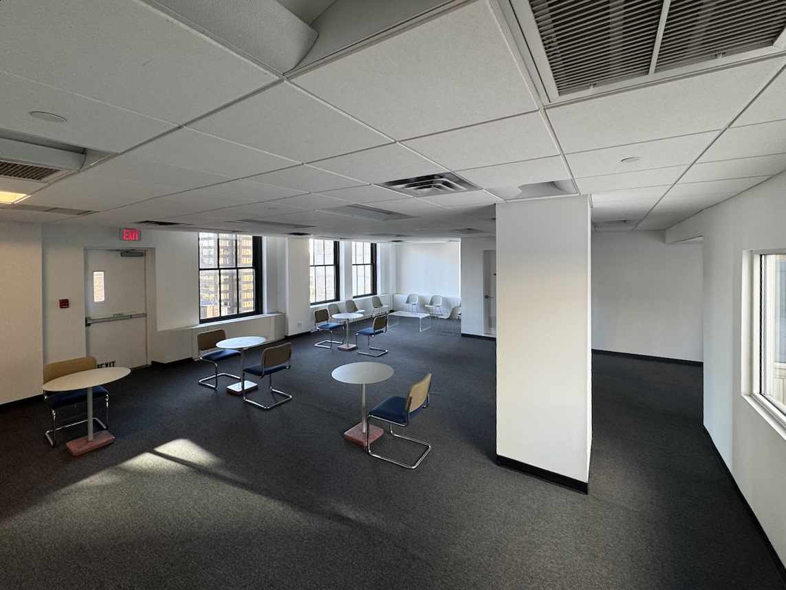 Open office on East 40th with round tables and natural light.